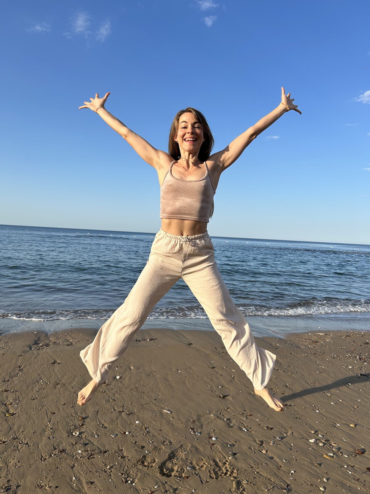 After — the body free, hands open to the sky.